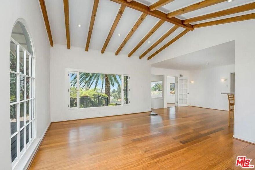 Hollywood Hills lifestyle at its finest! Perfectly positioned near the area's most iconic attractions -- including the Hollywood Bowl, Walk of Fame, Runyon Canyon, Griffith Park, Lake Hollywood, Universal Studios, plus countless studios, shops, and restaurants -- this property truly has it all. The light filled living room welcomes you with vaulted wood beam ceilings, recessed lighting, a classic brick fireplace, and picture windows framing the lush natural surroundings. The open kitchen is designed for both style and function, featuring a breakfast bar, dramatic range hood, and wood-beamed detail overhead. Step outside to your own private retreat: an expansive park-like yard with multiple decks that showcase sweeping views of the Hollywood Sign and sparkling city lights -- the perfect backdrop for evenings with a glass of wine or gatherings under the stars.