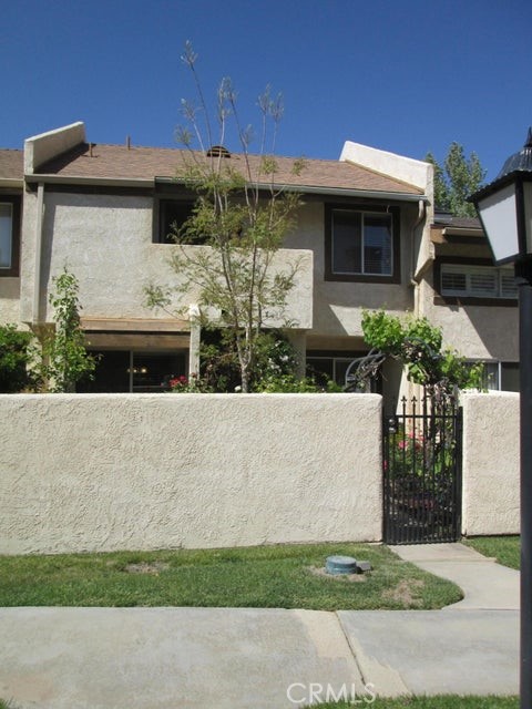 Beautifully Remodeled Condo located within a well established gated Community. Newer Paint, Baseboards, Laminate Wood Flooring downstairs and Carpet upstairs in the spacious bedrooms- Quartz Counters with decorative Glass Tile Backsplash in the Kitchen - Newer Appliances and Stainless Steel Sink. Quartz Counters in the Upstairs Baths along with new sinks, lighting and Laminate Wood Floors. Floor to Ceiling Tiled Fireplace for those chilly AV nights. Enjoy the gated Entry Courtyard or relax on the large upstairs deck. Pool, Spa and Tennis Court await your use! This one won't last -