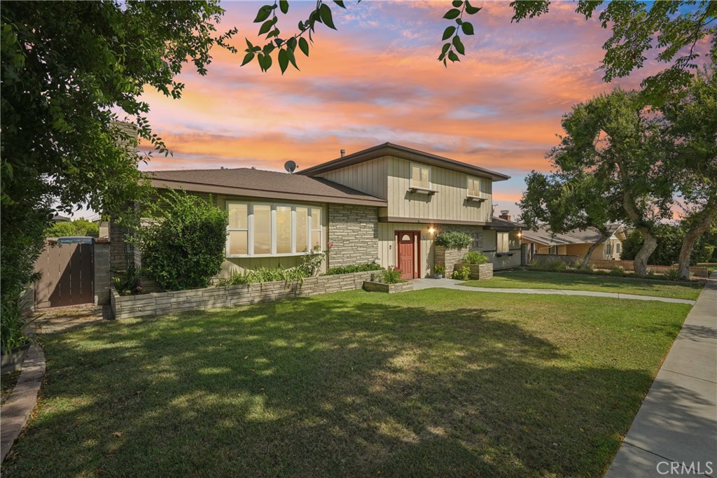 Discover this inviting two-story pool home perfectly situated in one of Upland’s most sought after neighborhoods. Sitting on a spacious 11,050 sqft lot this 2,668 sqft residence offers 4 bedrooms 3 bathrooms and a layout designed for both comfort and entertaining. From the moment you arrive you’ll be impressed by this homes curb appeal, mature trees, and stone accented planters. The welcoming walkway leads to the elegant front entrance setting the tone for what’s inside. The primary suite is conveniently located on the main level complete with a spa like bathroom featuring a soaking jetted tub, separate shower, dual vanity and a generous walk in closet. The kitchen is a true highlight boasting expansive quartz countertops, plentiful cabinetry and a breakfast bar that overlooks the living space. The main floor also includes a formal living room with a stone fireplace and luxury vinyl plank flooring that seamlessly connects to the dining area an ideal setup for gatherings. Did I mention there’s a bonus room? For whether you envision a home office, playroom or potential 5th bedroom the option is yours. Upstairs three additional bedrooms share a beautifully updated full bathroom. The home also includes a dedicated laundry room with built in cabinetry and a sink for added convenience. Stepping outside to your private backyard retreat you'll find these great features. A gated pool, grassy play area, mature trees and hardscape ready for those summer barbecues. A unique bomb shelter offers creative possibilities or simply additional storage space. The property also provides a wide driveway with RV parking and an attached two car garage. Located near highly rated schools and everyday conveniences this home offers both charm and functionality in one of Upland’s finest locations.