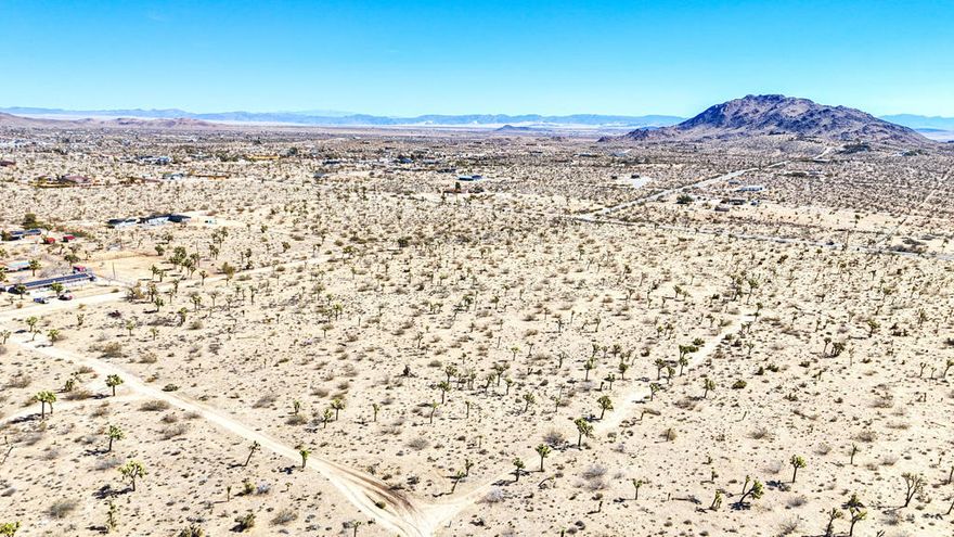Embrace the beauty of the high desert on this exceptional 5-acre lot, just a short drive from Yucca Mesa Road. With expansive mountain views, a level terrain, and the tranquility of open space, this property is perfect for those seeking a peaceful retreat or a prime building site. There's ample room to design your ideal home, complete with a pool, garden, or guest house--whatever your dream entails!And if you dare to dream bigger, pick up the other 3 parcels, offering the opportunity to expand your estate to 20 acres by acquiring the neighboring lots. Whether you choose to develop now or invest in your future, this parcel is a prime opportunity in the growing Yucca Valley market. Photo with red outline is all 4, 5 acre parcels together. Other APNs available: 0598-084-31-0-000, 0598-084-32-0-000, 0598-084-34-0-000.