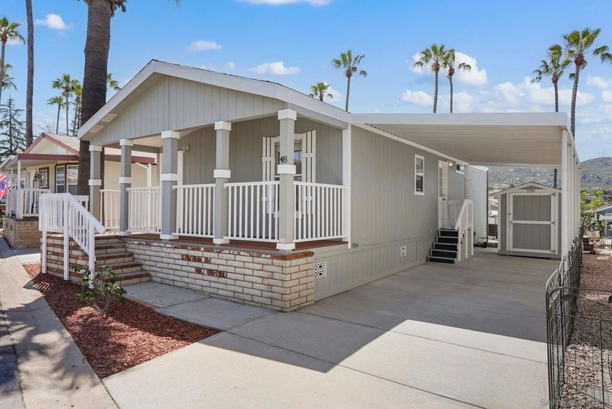 Welcome to your peaceful retreat tucked away on a gentle hilltop in one of the area's most desirable 55+ communities. This beautifully remodeled 2-bedroom, 2-bathroom home offers the perfect blend of comfort, style, and low-maintenance living.  Step inside to an inviting open floorplan that seamlessly connects the living, dining, and kitchen areas—ideal for both entertaining and everyday living. The home features luxury vinyl plank flooring throughout, combining durability with high-end appeal.  The modern kitchen is a true standout, equipped with sleek stone countertops, contemporary cabinetry, and quality appliances—perfect for preparing meals with ease. Natural light floods the living space, creating a warm and welcoming atmosphere.  Relax and unwind on the spacious porch, where you can enjoy your morning coffee or evening sunsets in total tranquility. Out back, you’ll find a charming garden—just the right size for tending plants or creating your own peaceful outdoor escape.