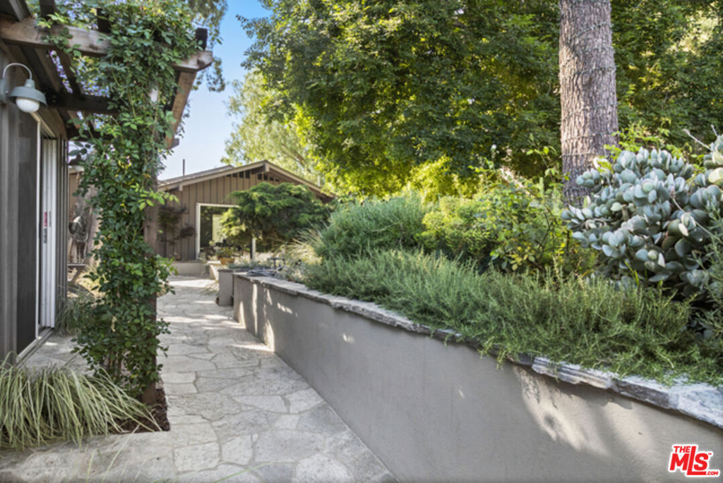 Vista Cottage: A private compound in Elysian Heights. A rustic sanctuary with Jetliner views, 5 minutes from all LA has to offer. Step onto your deck with sweeping views from Hollywood Sign to the ocean. Designer-renovated home, completed in 2022, blends mid-century elegance with cabin charm. Custom comfy furniture and high-end textiles throughout. Multiple fireplaces, heated bathroom floors, steam shower, washlets. High-end built-in kitchen flows seamlessly into open living spaces. Two lower bedrooms, custom-lit detached studio. This secure compound has towering pines, a private orchard, and professionally landscaped gardens with Koi pond. Ten steps to Elysian Park (600 acres of trails, Dodger Stadium), yet minutes to freeways 2/5/101. You can exhale here. You won't hear the neighbors or see them. Whether you're single locking in on your creative breakthrough (one actor wrote an award-winning film here), or wanting to teach your kids the value of nature (private orchard, vegetable gardens) and creativity (piano, painting studio, Museum-quality art on the walls), this is where you can exhale and recharge. Entertain under the stars. Relax in the hammock, make s'mores around the fire pit, or soak in the outdoor clawfoot bathtub while the city sparkles below. Pets welcomed. Furnished/unfurnished for 10 months to 2 years. Available 8/10 if furnished, 8/24 if unfurnished. Prices vary based on length and furnishing options. Housekeeping and Yoga classes can be arranged for a fee.