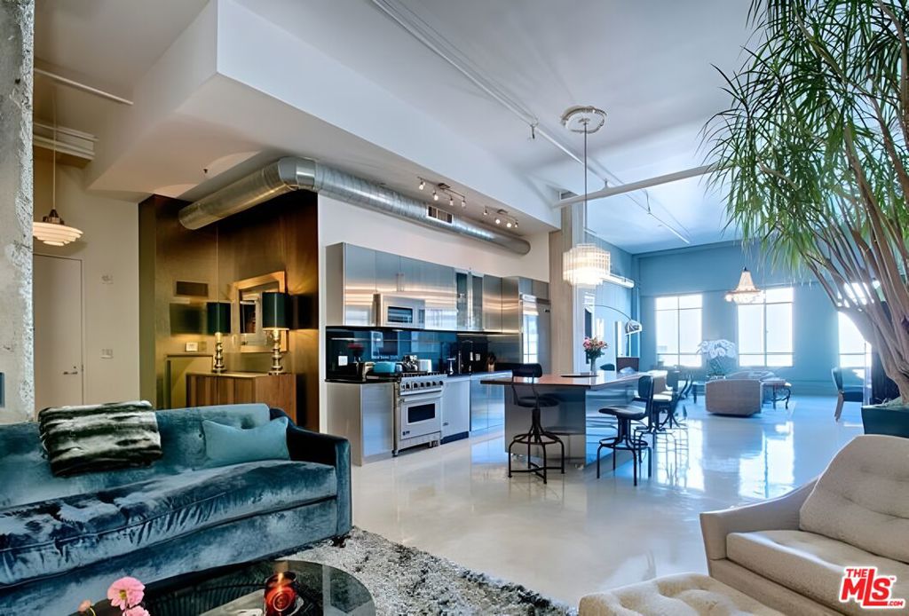 Situated on the 12th floor of the iconic Art Deco Eastern Columbia building, this spacious nearly 1500sf LIVE/WORK loft boasts upgraded finishes and a NY-style vibe. The loft features dramatic 14-foot ceilings, off-white concrete floors, and east views towards the iconic Orpheum marquee and the Broadway scape below. The spacious loft is beautifully appointed with high end finishes such as an open plan custom stainless steel kitchen with Viking appliances, designer island with built-in storage, separated bedroom with sheer curtains and closet with Elfa storage system. Ensuite bath features stunning Kelly Wearstler designed tile mosaic and tub, with W/D inside the closet. The living area has an open plan layout that is ideal for effortless entertaining. 1 covered parking space is included with the unit. The building has a stunning rooftop pool, sun deck, spa, and fitness center with breathtaking views of DTLA. There is a Kelly Wearstler designed lobby with a 24/7 reception desk and security, courtyard, dog area, and attached parking garage. Within blocks to everything including Whole Foods, Fashion District, Orpheum, Proper and Hoxton hotels, Metro, The Broad, Walt Disney Concert Hall, The Bloc, Fashion District, City Market South, Grand Central Market, and all the best dining, coffee and shops.
