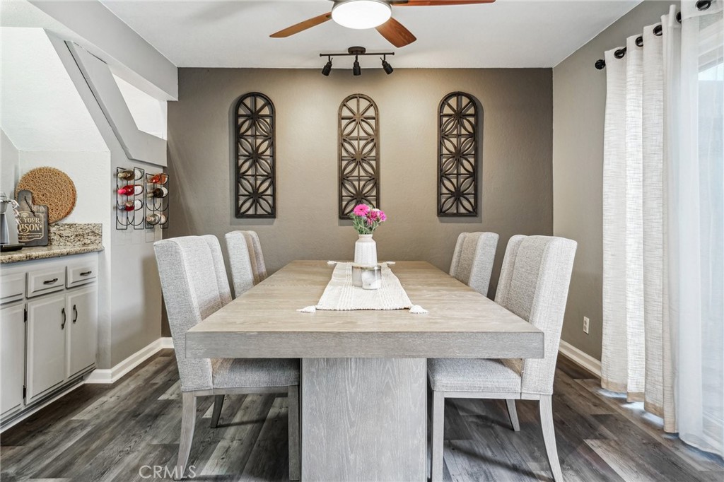 Updated Montclair Town Center Condo is ready for its new owner. Featuring 3 Bedrooms/ 3 Bathrooms with 1,426 sq ft of living space, a large private Patio and a 2-Car Garage. The interior of this upgraded home has vinyl plank flooring, textured ceilings, baseboards, and newer HVAC. The Living Room features a stacked stone fireplace and opens to the Kitchen with bar seating area, granite countertops, tile backsplash, white cabinetry, and appliances include a 4-burner cooktop, built-in oven, microwave, and dishwasher. The formal Dining Area as well as a half Bathroom complete the main floor. Take the staircase with wrought iron banister up to the 2nd floor where you will find all 3 Bedrooms including the large Primary Bedroom with mirrored closets, private Bathroom and a balcony with great views! There is also a full-size hall Bathroom for the 2 Secondary Bedrooms to share. The fully fenced Backyard Patio is ready for the new owner's design and also accesses the 2-Car Garage. Residents also get to enjoy a community pool, spa, and playground. Low HOA fee, and centrally located near schools, shopping, and more!