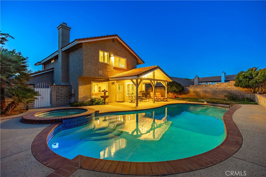 ***LIVE BEAUTIFULLY*** Upgraded 4-Bedroom Pool & Spa Oasis in the Heart of Rancho Vista - West Palmdale Cul-de-Sac Location! Welcome to this beautifully upgraded 4-bedroom pool and spa home, perfectly situated on a quiet cul-de-sac in the highly desirable Rancho Vista community of West Palmdale. Just a short walk to Rancho Vista Elementary and Hillview Middle School, this home offers the perfect blend of comfort, style, and convenience. As you enter, you're welcomed by soaring high ceilings that create a bright and airy ambiance. Plantation shutters throughout the home add a touch of timeless elegance, while the spacious family room with LED lighting and a cozy fireplace is ideal for relaxing or entertaining. Downstairs bedroom with a downstairs half bath. The upgraded kitchen features stainless steel appliances, a stylish tile backsplash, and plenty of cabinetry for storage and prep. Step outside to your own private retreat with a custom patio, perfect for outdoor dining and lounging. The pool and spa area is the showstopper, boasting two tranquil waterfalls, a newer pool pump, and complete block wall fencing for added privacy. The home is also configured for ADT security, including an iPad touchscreen control panel for added peace of mind. Even the garage has been upgraded with a Pebble Tech-style epoxy floor coating, offering both durability and style. This turn-key home is an entertainer's dream in one of Palmdale's most sought-after neighborhoods. Don't miss your opportunity to own this Rancho Vista gem—schedule your private showing today!