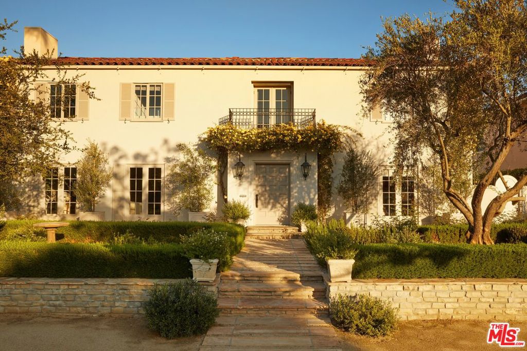 Featured in Architectural Digest. 1922 Walker & Eisen Mediterranean Revival, carefully and completely renovated in 2020. Designed by Disc Interiors, built by Plus Development. Located in the historic Los Angeles neighborhood of Windsor Square, walking distance to Larchmont Village. Enter the home through Moroccan limestone floors framed by curved archways: one leading to a wood paneled home office and the other leading to a formal living room with wood burning fireplace and herringbone oak floors. The home spares no expense, from plastered walls to custom carved marble and stone, with Waterworks fixtures throughout. Amenities include a home theater, 5 bedrooms in the main house, a separate guest house with living room and kitchen, gym, showroom style primary closet, steam, and a 2 car garage. Smart home with Savant systems. Step into the backyard to find edible organic gardens, a lap pool, lawn and a gas fire pit. Gated and private with long cobblestone driveway and high hedges. A true Hollywood hideaway.