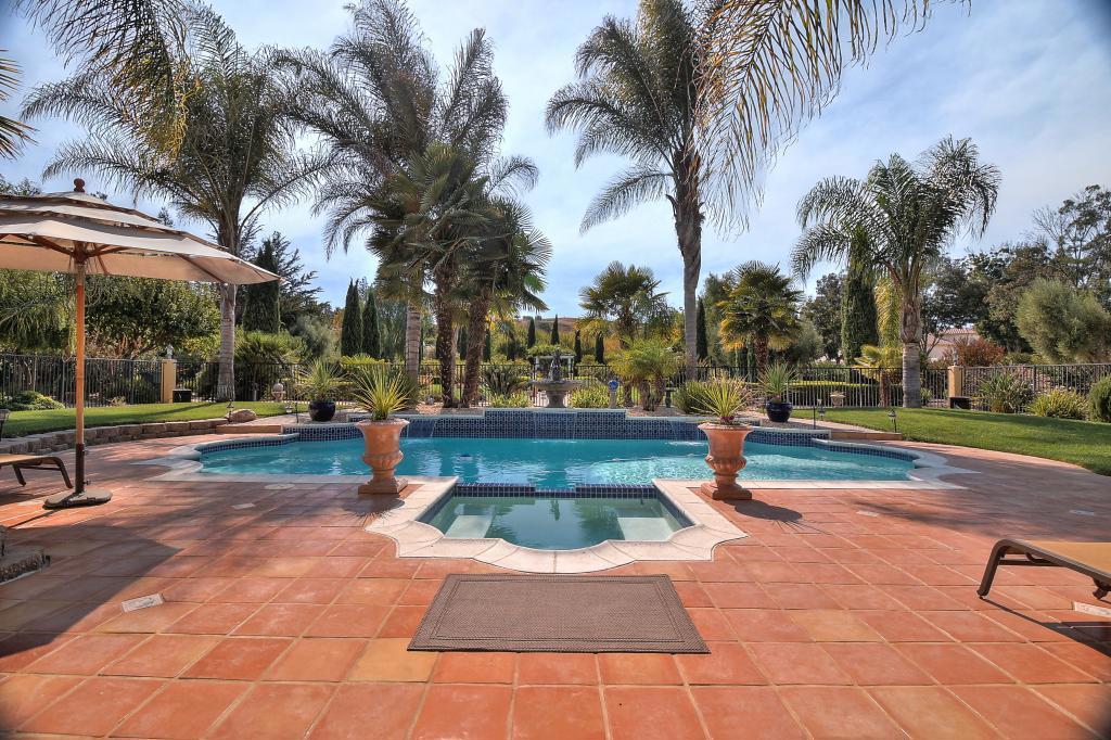 Stunning SINGLE Story home in Monte Bello Estates, a gated community. This home has never been on the market and just wait until you see the gorgeous grounds. 4 bedrooms 3.5 Baths, Office/library, Living Room, Dining Room, Family Room, Outdoor Kitchen, Fireplace, Swimming Pool and Vineyard! Absolutely Stunning