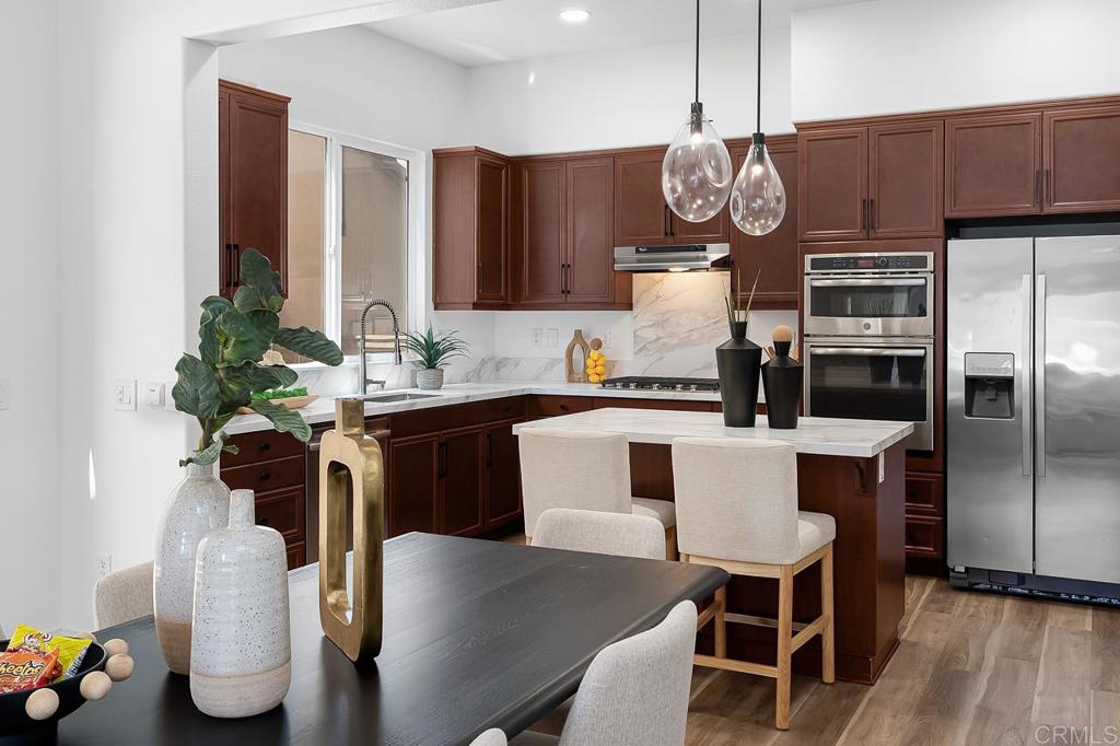 Set in a quiet, tucked-away pocket of Chula Vista, 1686 Pember Ave is a detached three-story home that checks all the boxes for comfort, space, and style. From the moment you step inside, you're welcomed by an open-concept layout with sleek new flooring, fresh paint, and natural light pouring through every room. The main level flows seamlessly from the spacious living area with fireplace and built-in beverage fridge. A designer kitchen featuring quartz countertops, statement lighting, and an oversized island perfect for casual dining or entertaining. Upstairs, the primary suite serves as a true retreat with its own private balcony, large walk-in closet, and spa-inspired bath with soaking tub and dual vanities. Two additional bedrooms, a full guest bath with double sinks, and a dedicated laundry room complete the second floor. On the third level, a generously sized suite with its own full bath offers flexible use as a guest quarters, home office, or bonus room. With dual-zoned A/C, a two-car attached garage, and a private front patio for outdoor lounging, this home offers thoughtful upgrades and a layout ideal for modern living, all within a well-maintained community near shopping, schools, and more. Low HOA fee that gives access to the Mentecito Clubhouse