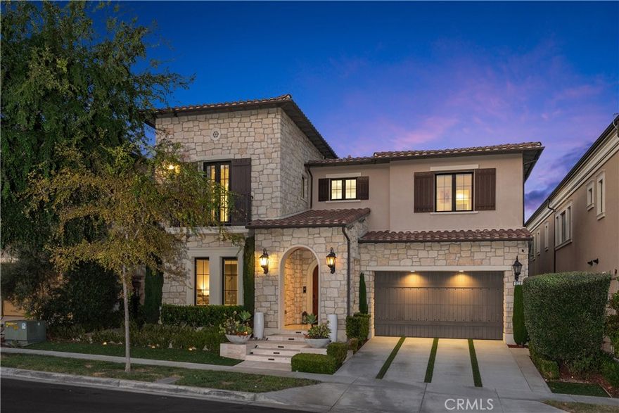 Presenting one of the most exceptional contemporary estate homes in Irvine, this immaculate “Capri” Portofino residence blends luxury, comfort, and location within the prestigious 24/7 guard-gated community of Hidden Canyon. Situated on a premium 8,700 square foot cul-de-sac lot, the home offers nearly 4,980 square feet of living space with five ensuite bedrooms and six baths. Perfectly positioned on a quiet street near the private community pool, park and clubhouse, it sets the stage for refined living in one of Irvine’s most desirable and ideally located neighborhoods. From the moment you enter the two-story grand foyer with its dramatic staircase and chandelier, the home captivates with volume, light, and elegance. Oversized windows and expansive pocket doors frame the interiors, creating seamless indoor-outdoor flow and filling the residence with natural light. The main level is anchored by a chef’s kitchen that offers dual islands, dual ovens, dual dishwashers, a Sub-Zero refrigerator, Wolf appliances, a large walk-in pantry, and a coffee station, all adjacent to the California Room for year-round entertaining. The open layout includes a formal dining room, expansive great room, and additional living room, complemented by imported tile flooring, designer fireplaces, and sophisticated finishes throughout. A main-level bedroom suite adds comfort and flexibility for guests or multi-generational living. The backyard feels like a private resort with its generous grassy play area, covered loggia, built-in BBQ, fire pit, and elegant fountain—an inviting setting for both intimate gatherings and larger celebrations. Upstairs, the luxurious primary suite is a private retreat with oversized windows offering sweeping city light views. Its spa-inspired bath showcases a walk-in shower, soaking tub, and custom-designed closet, while an enclosed gym or office adds a unique touch of versatility. Three additional ensuite bedrooms, a loft, and a convenient upstairs laundry room complete the upper level. Additional highlights include an upgraded security system, 20 solar panels for energy efficiency, and a three-car garage. Hidden Canyon is recognized as one of Orange County’s most exclusive contemporary communities, combining privacy, prestige, and proximity to award-winning schools, world-class shopping, dining, and the coast. An ideal location with quick access to the 5, 405 and 133 Freeways. Welcome to home to your modern luxury estate in the coastal hills of Irvine.