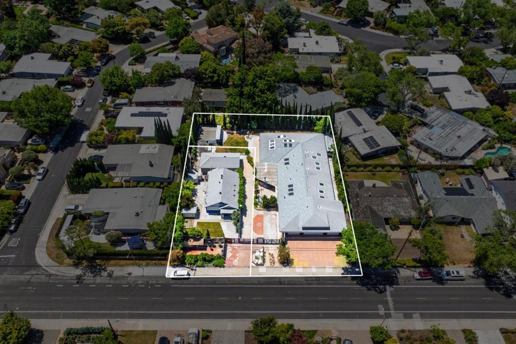 Set on a generous 0.51-acre lot, this rare and versatile opportunity features two separate homes and multiple outbuildings on one parcel. Providing exceptional flexibility for multi-generational living, rental income, or future development in a desirable Palo Alto location. The main house, a custom-built residence, offers bright interiors and seamless indoor-outdoor flow with vaulted ceilings, custom Alderwood cabinetry, radiant heating, Italian porcelain tile flooring, and energy-efficient features. It includes an attached ADU with its own entrance, spacious bedroom, living area, kitchen, and private bath ideal for extended family, guests, or rental use. The attached oversized 4-car garage adds ample space for parking and significant attic storage. A charming second home with private yard and entrance, delivers immediate income potential, use as a guest house, office, or studio. Two additional outbuildings outfitted with electricity provide flexible options for workshops, creative studios, fitness areas, or extra storage. With subdivision potential (buyer to verify), this property offers exciting opportunities in one of Palo Alto's most coveted locations near parks, shopping, commuter routes, Stanford, tech campuses, and top-rated schools.
