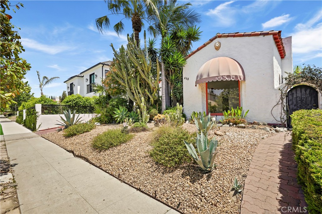 Spanish Charmer with Endless Potential Near Melrose. Discover a fabulous single-story Spanish-style home offering over 2,500 sq ft of character and opportunity. The main house at 1,930 sq ft, showcases timeless details and original charm—ready for you to restore to its former glory. A dramatic living room with soaring ceilings and a brick fireplace flows seamlessly into the formal dining room, kitchen with a sunlit breakfast nook, and a convenient laundry area. Three bedrooms and two baths include a versatile third bedroom currently used as a family room, offering flexible living options. The spacious converted garage and detached guest unit with an upstairs bedroom and bath provide endless potential for additional income, work-from-home space, or a private retreat. Set on a 6,601 sq ft lot, the backyard is a private oasis featuring a sparkling pool, spa, lush landscaping, and fruit trees. Located in one of the most desirable neighborhoods near vibrant Melrose, this property is an exceptional canvas to re-imagine or restore into a stunning Spanish retreat.