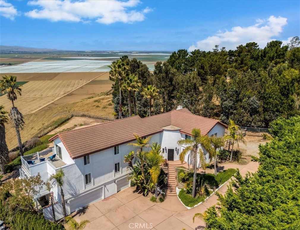 Unobstructed, breathtaking views of the valley, hills, and on a clear day, the ocean! Enjoy remarkable sunrises, stunning sunsets, and it is a stargazer's haven! Under $410 a sq. ft., this 4024, 5-bedroom, 3.5 bathroom home is a supreme value! The main level offers a multigenerational option with a large primary suite and the potential of a private entrance, 3 closets, and a private ensuite bathroom! Also on the main level is an amazing living room featuring abundant windows, lofty ceilings, and an inviting fireplace, impressive, warm, & comfortable! A bright, improved kitchen with abundant cabinets, soft-close drawers, ample counters, rolling island, & walk-in pantry connects to a large family room. The sellers are offering a flooring credit for the buyers to personalize this wonderful space! Extensive windows & 4 patio/ French doors exit to a sweeping deck, enjoy the views and relax! Upstairs is a 2nd primary suite with a personal deck to enjoy panoramic views & an ensuite bathroom, 3 more bedrooms, and a 3rd bathroom. The 3-car garage is over 920 sq ft plus room for RV/Boat and extra parking to the west of the home, & easy access to the level part of the large yard. No HOA, so this property is only limited by your imagination. Build a shop, own horses, & more! Nipomo is dubbed one of the best places to live! Enjoy award-winning golf, beaches, wineries, & close access to HWY 101 & San Luis Obispo Airport!