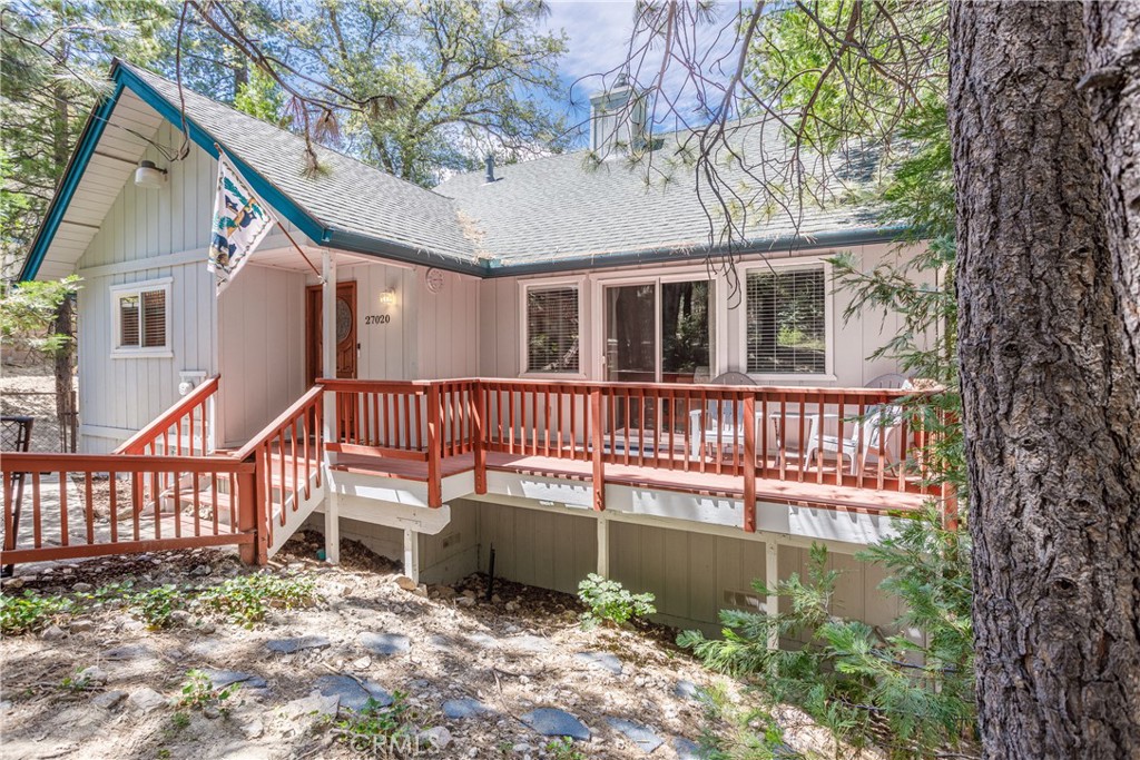 Set on a quiet cul-de-sac across from the San Bernardino National Forest — where trails begin just steps away, including one that connects to the scenic Will Abell Memorial Trail — this furnished, move-in ready lake house resides in one of the most rare and private settings in all of Lake Arrowhead, blending seclusion with convenience. You can sit on the front deck with a cup of coffee in total bliss, surrounded by crisp mountain air, towering pines, and nothing but the sounds of nature. With deeded lake rights included, enjoy access to Lake Arrowhead’s private waters along with expansive decks, a private dedicated hot tub space, and immersive forest views: the ultimate retreat in what many call the "Alps of Southern California." Inside, the cabin-style charm continues with a dramatic stone fireplace that climbs the living room wall, a stunning rock-face breakfast bar, butcher block countertops, and a marble herringbone backsplash. The kitchen and both bathrooms have been tastefully updated to reflect the rustic mountain aesthetic. A true harmony of lake house comfort and cabin escape.