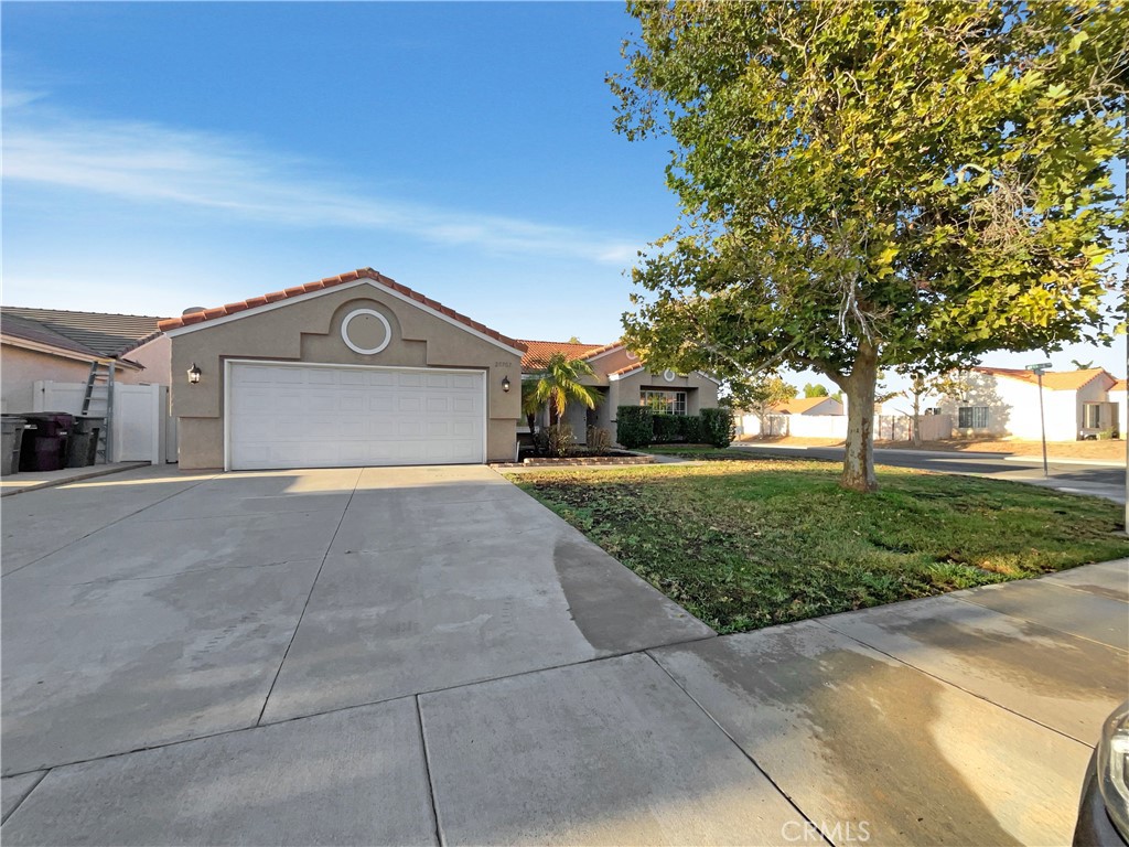 Welcome to this beautifully maintained property that boasts a host of desirable features. The living room is warm and inviting with a cozy fireplace, complemented by a neutral color paint scheme throughout the house. The kitchen is a chef's dream with a functional island and all stainless steel appliances. The primary bedroom is a retreat with a spacious walk-in closet. The primary bathroom features double sinks for convenience. Outside, enjoy a covered patio perfect for entertaining and a fenced-in backyard for privacy. The home's exterior has been recently refreshed with new paint. This property is a must-see for those seeking a comfortable and stylish living environment.. Included 100-Day Home Warranty with buyer activation