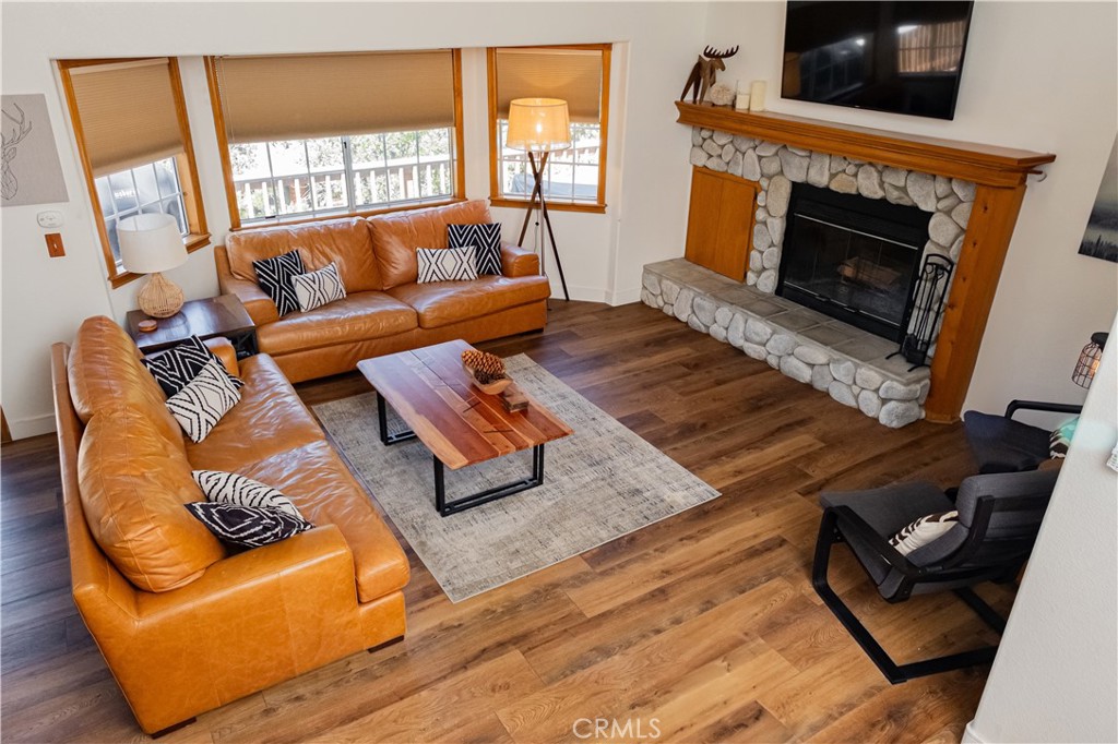 Tucked away in the mountains, this warm and welcoming cabin is the perfect getaway for a full-time retreat or a vacation home. Featuring 3-bedroom, 2.5-baths and a spacious loft that you can use as an entertainment area or an extra bedroom. Surrounded by towering trees, this home offers a peaceful escape with stunning views from the main level deck, ideal for relaxation or entertainment. Inside, the open concept living space is filled with natural light, featuring vaulted ceilings and lots of windows that bring the beauty of the outdoors in. The well-appointed kitchen seamlessly connects to the dining and living areas, creating a warm and inviting atmosphere. Downstairs the primary suite provides a private deck, while the additional bedrooms and loft offer ample space for guests. Stay comfortable year-round with air conditioning in the living room and loft. Convenience is key, with a level-entry two-car garage and on a county-plowed & maintained road, providing peace of mind and year round accessibility. Additionally, a workroom below the house offers extra storage or workspace. Fully fenced yard, perfect for pets and gardening. With Lake rights, you'll have full access to Lake Arrowhead and all its recreational opportunities. Additionally, the property is equipped with a whole-house generator and additional 3 parking spaces. Whether you're looking for a full-time residence or a vacation getaway, this mountain home offers the perfect blend of comfort, nature, and recreation. Home comes FULLY FURNISHED!