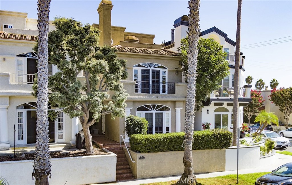 Stunning Tuscany-style coastal gem just two blocks from the sand on an elevated lot! This bespoke trilevel residence
blends elegance with beachside ease, offering nearly 3,000 sq ft of living space. Enter the private front door into an open
formal living and dining layout with wide windows, a fireplace, and French doors that flow to a front patio. The entire first
floor is finished with elegant travertine flooring. The recently remodeled gourmet kitchen showcases modern quartz
countertops, soft-close cabinetry, and a generous eat-in large counter adjacent to a cozy nook with French doors
opening to a private courtyard. Mid-level includes a 2-story towering family room with a fireplace. The master suite is your
sanctuary — private balcony, fireplace, spa bath, built-in cabinetry, and walk-in closets. In the rear is a secondary
bedroom with an en-suite bath. The top floor hosts a third bedroom with a full bath, a generous office nook, and dual rooftop
terraces with peekaboo ocean view. In addition to a 2-car garage, this home boasts a full-length driveway — a rare
luxury in Huntington Beach — providing ample parking. With exquisite finishes and walking distance to the beach,
parks, shops, and Main Street, this home captures the best of coastal living.