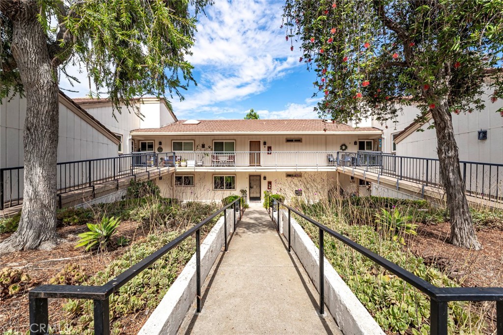 Welcome to your Catalina retreat in Laguna Woods Village. This spacious two-bedroom, two-bath home offers 1,188 square feet of comfortable living with a sought-after floor plan designed for ease and function. Located in a quiet setting, the property includes a private detached single-car garage and opens to lush greenery with scenic views of the Saddleback Mountains. The living room is filled with natural light and features wide sliding glass doors that lead to a private patio, the perfect spot to relax or entertain while taking in the mountain backdrop. The dining area flows seamlessly into the kitchen, which is outfitted with traditional cabinetry, a double sink, and white appliances. The primary suite includes its own bath with a walk-in tub and thoughtfully placed grab bars for safety and convenience. The second bathroom offers a walk-in shower, making both spaces practical and accessible. Two generously sized bedrooms provide flexibility for overnight guests, a home office, or a creative space. Additional features include an in-unit laundry with full-size washer and dryer, tile and wood-style flooring, fresh paint, and ample storage throughout. Living in Laguna Woods Village means more than owning a home—it means enjoying one of the premier active adult communities in Southern California. Residents have access to a 27-hole championship golf course and a nine-hole executive par-three course, five swimming pools, tennis and pickleball courts, modern fitness centers, and clubhouses that host activities, classes, and social gatherings. The community also features an equestrian center, a performing arts theater, and over 250 clubs for every interest imaginable. This Catalina Model combines a comfortable floor plan, beautiful views, and resort-style amenities, offering not just a home but a lifestyle of recreation, relaxation, and connection.