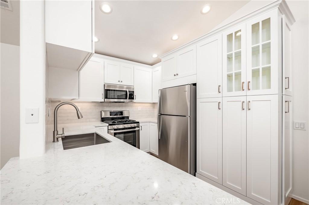 $3,100 per month, no animals please, good credit required. Fully remodeled exuding elegance in every detail. A private entrance leads to this upper end unit condominium that is attached by one wall with only garages below. White shaker kitchen cabinetry with soft close features, quartz counters & stainless steel appliances including gas range, dishwasher, microwave & refrigerator. Living room with fireplace & cathedral ceilings opens to dining room & kitchen. Large balcony to enjoy the sunsets. Primary suite includes white shaker dual sink vanity with soft close features & quartz counter, custom mirror & pretty lighting, Roman soaking tub/shower, walk-in closet & privacy door to water closet. *** Secondary bedroom does not have a door nor a closet and has an opening with a pony wall to the living area best used as a home office, den, occasional guest room *** Second bath has a newer vanity with soft close features and warm wood look tile floors that flow through the traffic areas. Direct access garage with 240 Volt receptacle for car charging, epoxy floor and storage racks. Central air conditioning and heat. Full size clothes washer & dryer. You will love this impeccable home and its location with plenty of guest parking, beautiful pool & spa area. Convenient to Aliso Viejo Town Center for entertainment, movies & restaurants. Close proximity to gyms, parks, walking, hiking and mountain biking areas. Landlord pays HOA fee & trash.