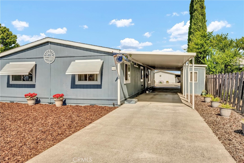 Enjoy a home away from home or settle in full-time in this spacious 4-bed/2-bath home nestled in the Pier 1900 subdivision WHERE YOU OWN THE LAND! Pier 1900 is a versatile and welcoming community with NO AGE RESTRICTIONS! This well-maintained property features a BRAND-NEW ROOF offering peace of mind for years to come. With low-maintenance front & back yards, you'll find easy upkeep while you're away or the perfect canvas to add your personal touches and bring out its charm. There is ample parking under the attached carport, including space for your vehicle(s) and multiple boats with the added convenience of a pull-through breezeway with street to street parking. Step inside to a freshly painted interior featuring high vaulted ceilings in the living room, kitchen, and primary bedroom. A kitchen skylight brings natural light into the heart of the home, where you'll find generous counter and cabinet space for your cooking needs. Carpeted bedrooms and living areas add comfort, while tiled floors in the kitchen, laundry room, and bathrooms offer easy maintenance. The primary suite features views of Mt. Konocti from the Eastern window and includes a walk-in closet to accommodate your wardrobe with ease. Separate large family room offers flexibility for additional living space. The home's split floor plan provides privacy and balance, and the property is fully electric. Land is owned beneath, so you don't have to worry about space rent increases! HOA includes option for boat and trailer storage for homeowners. Unit #52 is located near the Bocce Ball court and across the street from transportation and shopping. Schedule your tour today and enjoy the best of Lake County living!