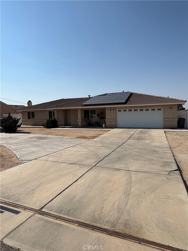 Large one story home being offered for sale to new owners who are looking for value, convenience, and a delightful place to call home. This home features tile and/or hardwood floors in every room. Large and convenient, 4 bedrooms with a split floor plan and new light fixtures. The home also offers two full bathrooms each with shower/tub combo. The principal bathroom has double sinks. This home features solar panels and window shutters in every room for energy efficiency. There is room for two cars in the garage, a side gate to park more in the back and also a few in the front yard. A circular driveway adds convenience and curb appeal. The back yard has a chainlink fence featuring a vinyl fence in front of it. The front has wrought iron fence and gates for safety and privacy. This home was built with a tile roof that provides cover and great looks as well. The kitchen is fully equipped with a gas freestanding range, dishwasher, and a stainless steel fridge. Recessed lights create the perfect ambiance for the chef of the house. The laundry room off the side of the kitchen is equipped with a washer and dryer.