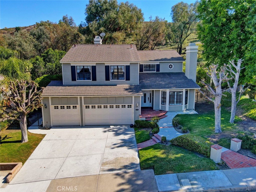 Welcome to this lovingly cared for home in the sought after community of Nohl Crest in Anaheim Hills. This wonderful 2802 square foot home has 4 bedrooms, two and a half baths and sits on a large lot. From the moment you arrive you'll notice the amazing views of the hills and the inviting curb appeal and charm of this residence. Step inside to a spacious and bright dual-level floorplan designed for both everyday living and entertaining. The formal living and dining areas feature large windows that provide plenty of natural light. The updated kitchen boasts modern appliances, new quartz counter tops, newer soft close cabinets and drawers and a convenient breakfast nook that opens to the family room. Get cozy on those chilly evenings with fireplaces in both the living room and family room. You will also see the large convenient laundry room and 1/2 bath downstairs. Upstairs the large primary bedroom has ample space for work out equipment or a home office. You will also see the large walk-in closet and the spa like bathroom with dual sinks and a separate shower and large soaking tub! Three additional bedrooms provide comfort and flexibility for family, guests or a home office. The backyard is perfect for entertaining family and friends! Ample parking with your attached 3 car garage and large driveway. This home is in close proximity to top-rated schools, parks, shopping and dining, with easy freeway access.