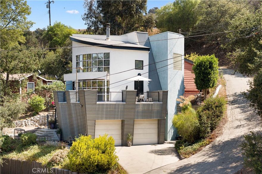 View! Very well built and maintained! This 1991 rebuilt, unique contemporary property features 2 bedrooms, plus a den (which could be the 3rd bedroom), 3 full bathrooms, and a 2-car attached garage. High ceilings greet you at the entry. The upgraded kitchen boasts beamed ceilings, light Corian countertops, a center island, a full mosaic backsplash, and top-tier appliances. The open and bright living room includes a gas fireplace, while the family room features wood flooring, a media center, a wood-beamed ceiling, and its own fireplace. Both the living room and family room provide access to the large balcony, which offers beautiful hill views. The primary bedroom has a vaulted ceiling, his and hers closets, and a primary bathroom with a designer tile floor, a glass block window, and a large walk-in shower. The second bedroom also has a vaulted ceiling. The bonus den could easily be converted into the 3rd bedroom. Additional features include custom lighting, custom window roller shades, custom two-tone paint, double-pane windows, metal wall panels, and a skylight. The private backyard is peaceful and tranquil, perfect for family gatherings and relaxation. Elegant spiral stairs lead to the large balcony, where you can enjoy the rolling hills view. This home offers easy access to the center of Chino Hills and nearby cities in Orange County. It is also located within the boundaries of excellent Chino Hills schools, including the award-winning Ayala High School, Canyon Hills Junior High, and Litel Elementary.