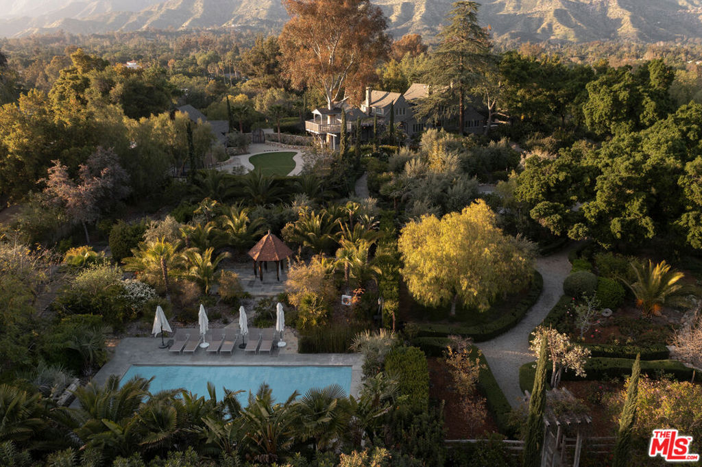Perhaps the finest estate in the Ojai Valley, this breathtaking property is situated on 50 +/- acres and boasts two grand residences, just steps away from vibrant downtown Ojai and the world-renowned Ojai Valley Inn.Originally built in 1927 as a winter retreat for the founder of the Diamond Match Company, this estate has been recently renovated and impeccably maintained, showcasing its original charm and beauty. Stately gates open to an impressive driveway leading to the main house. Inside the main house, you will find stunning details, such as tongue and groove bleached pine paneling, a dramatic, yet intimate great room with a stone fireplace, and a large picture window framing vistas of the Topa Topa Mountains. The cathedral-ceiling music room, chef's kitchen, cozy family/media room, large dining room, guest bedroom, two bathrooms, as well as an eat-in area with a window seat and views and a large laundry room complete the first floor. Upstairs, you will find a primary suite sanctuary and three bedrooms. Terraces surround the main house, oriented to enjoy the views of the surrounding property and mountains.In addition to the main house, the estate features a second residence, which includes a large great room with a fireplace, dining room, screen porch, four bedrooms, and three bathrooms. There is also a separate guest studio with a full bath, as well as a Dojo building. An entertainment area features a pavilion, Santa Maria-style barbecue, and terrace, boasting head-on views of Ojai's famed Pink Moment, making it the perfect location for entertaining guests or hosting events.The estate offers meandering pathways through gorgeous mature and manicured landscaping, with a hidden pool, meditation area, citrus orchard, chicken coop, built-in trampoline, a treehouse with birds-eye views of the Ojai Valley, and coffee plants being grown, all set amidst rolling meadows. There is also potential for horse facilities, larger orchards, and hobby farming.This is a once-in-a-lifetime opportunity to own one of the most exquisite properties in the Ojai Valley, with unparalleled luxury, stunning mountain views, and endless potential for creating your own private oasis.