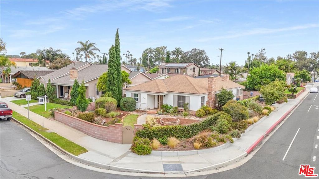 Nestled on a desirable street in one of Huntington Beach's most sought-after neighborhoods, this charming home with an oversized lot offers endless possibilities. Perfect for a family ready to move right in or as an exceptional opportunity for future development, the property sits on a rare corner lot with exceptional curb appeal. Inside, fresh paint and brand-new flooring create a bright, inviting atmosphere. The kitchen and primary bath showcase timeless mid-century charm, offering unique character that's hard to find. The expansive front and backyard are lushly landscaped, providing vibrant greenery and plenty of space for outdoor entertaining, play, or gardening. Whether you're seeking a move-in-ready home or a prime development opportunity, this Huntington Beach gem delivers both location and potential. There is an opportunity to convert the 2nd living room of of the kitchen to an optional 3rd bedroom.
