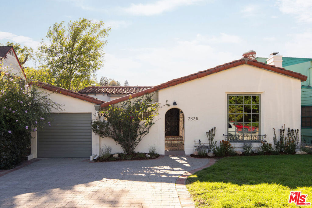 A stone's throw from the Silver Lake Reservoir sits this Spanish Revival Bungalow that truly embodies the old real estate adage, "location, location, location." Nestled on a quiet street in one of the most desirable areas of Silver Lake, this thoughtfully restored single-story home offers 3 bedrooms and 2 bathrooms. Brimming with nearly a century of character stunning beamed ceilings, oak floors, and stained glass. The reimagined kitchen features classic tile countertops and updated appliances, while bathrooms showcase vintage tile that beautifully preserves the home's historic charm. Multiple outdoor spaces include a welcoming front courtyard with a fountain and a private grassy backyard with new landscaping and irrigation. Located in the coveted Ivanhoe School District and just blocks from beloved local shops and eateries, it offers both serenity and convenience. Just moments away from grocery stores (Whole Foods, Gelson's, Trader Joe's) and the Silver Lake Meadow.