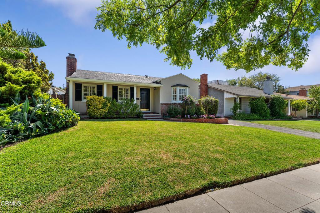 Nestled on a tree-lined street in Pasadena's sought-after Daisy-Villa neighborhood, this inviting home offers timeless appeal and thoughtful updates. A manicured lawn accompanied by blooming solanum topiary trees and colorful geraniums leads to a welcoming covered brick porch, setting the delightful tone for the interiors. Behind the handsome door, gleaming wood floors flow throughout the spacious living room, where a classic brick-hearth fireplace is flanked by windows that bathe the space in natural light. An additional wall of windows provides views of the porch and front yard, enhancing the room's open, airy ambiance. The formal dining room, accented by a transitional modern chandelier and bay windows overlooking vibrant blooms, connects seamlessly to the updated kitchen. Featuring beadboard paneling, stainless steel stove/oven and dishwasher, granite countertop and white storage cabinets, this efficient kitchen combines style with functionality. A bright good-sized bedroom with wainscoting and generous closet spaces is the perfect child or guest bedroom. The centrally located full bath features a modern floating vanity, a separate tub, and a frameless glass shower. The primary bedroom offers a versatile sitting area ideal for relaxing or in home office and a separate private sleeping quarters featuring double mirrored closets. Sliding glass doors open directly to the brick patio and sparkling pool, framed by lush bougainvillea--perfect for entertaining or unwinding in your own backyard retreat. Additional highlights include plantation shutters throughout, ceiling fans with lights, a newer 200-amp electrical panel, and mature orange trees. The detached two-car garage, equipped with an automatic door opener, half bath for poolside convenience, and washer/dryer hookups, presents excellent potential for an ADU or other customized uses. Ideally located near Gwinn Park, Alice's Dog Park, local dining, convenient freeway access and just moments from the excitement of the annual Rose Parade route, this charming Pasadena home is ready for you to make it your own!