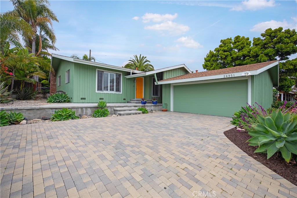 Located in the highly desirable Palisades neighborhood of Capistrano Beach. This single level home sits high on a prime lot perfect for sunsets and ocean breezes. Upon entering the home you are greeted with vaulted wood ceilings, hardwood floors and an abundance of natural light throughout. The open living room includes the kitchen and dining with a wood burning fireplace. Adjacent is a spacious step-down studio, den or office space with double door access to the private backyard. Two bedrooms, two bathrooms and an inside laundry room complement the 1950's charm. This home has a detached 2 car garage that is accessed through a breezeway. Wrap around landscaping with low drought native plants. Located a short distance to bluff top Pines Park, Doheny State Beach, Sprouts shopping center and highly rated Palisades Elementary School. Great home in a hidden gem of a neighborhood. No HOA's.