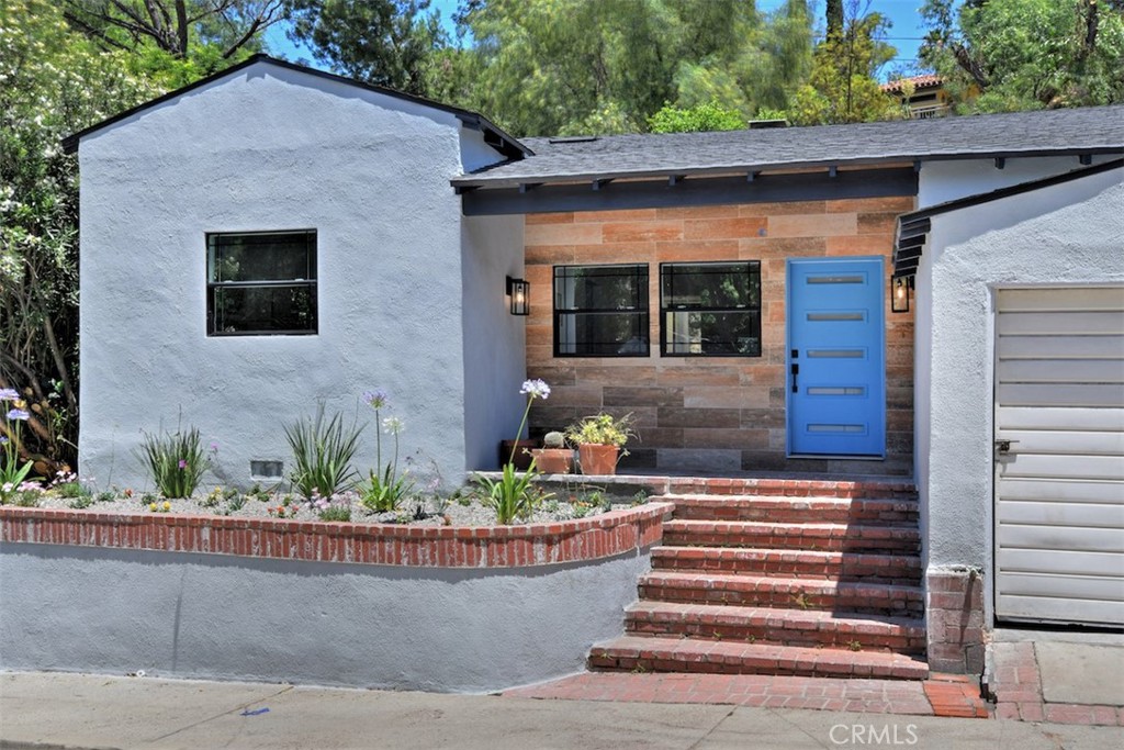 Welcome to this stunningly remodeled Studio City home, perfectly situated within walking distance of Ventura Boulevard and the renowned
Carpenter Elementary School. Step inside to discover an open and luminous living room adorned with soaring ceilings, exposed beams, and an
exquisite gas fireplace boasting black and gold marble accents. The dining area seamlessly connects to the backyard, creating an ideal setting for
indoor-outdoor entertaining, complemented by a modern chandelier. No expense was spared in the creation of the kitchen, which stands as the
crown jewel of this residence. It showcases high-end appliances, custom cabinetry, an oversized farmhouse sink, a deluxe kitchen faucet, and
luxurious calacatta quartz countertops. The primary suite impresses with dual sinks, an expansive shower featuring a rainfall showerhead, and a
freestanding soaking tub. The second bedroom is generously sized and boasts its own en-suite bathroom. Conveniently located near the kitchen,
you'll find a half bathroom and laundry area. The finished attic serves as a versatile space, ideal for a third bedroom, office, den, or a delightful play area
for kids. Step outside to the backyard oasis adorned with newly laid brick pavers, a barbecue area, and a convenient gas line for seamless
entertaining. With a 2-car garage and a perfect blend of style and functionality, this home resides in a prestigious south-of-the-boulevard
neighborhood. Enjoy a short stroll to Carpenter Elementary, the farmers market, Trader Joe's, and an array of exceptional shops and restaurants
that the valley has to offer. Don't miss the opportunity to make this captivating residence your own!
