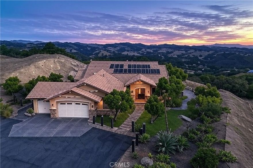 Set high above the Central Coast in the prestigious Oak Ridge Estates, this spectacular executive estate sits on one of the community’s highest lots, offering some of the most commanding views in Atascadero. From sunrise to sunset, enjoy unobstructed 360-degree vistas of the Santa Lucia Ridge, rolling valleys, and even distant glimpses of the Pacific Ocean. With its elevated setting, expansive layout, and resort-style amenities, this home was designed to deliver both luxury and livability.



Inside, soaring vaulted ceilings, oversized rooms, and an open yet versatile floor plan create a sense of scale and sophistication. Travertine and hardwood floors flow throughout multiple gathering spaces, including a dramatic sunlit great room, a cozy family room with fireplace, a formal dining room, and a charming breakfast nook. At the heart of the home, the gourmet kitchen invites both entertaining and everyday living, with a large island and breakfast bar, abundant cabinetry, expansive counter space, and even a built-in desk for added convenience.



The primary suite is its own private sanctuary, complete with a fireplace, custom built-ins, dual walk-in closets, and a spacious sitting area perfect for unwinding. The spa-inspired bath, with its generous proportions, completes the retreat-like experience. Smart home features add peace of mind and efficiency, including Nest temperature control, a whole-house fire suppression system, an EV charging station, and an owned solar array with battery backup.



Equally impressive, the outdoor spaces are crafted for entertaining and relaxation. Expansive patios and terraces extend the living areas outside, with a fully equipped outdoor kitchen, BBQ, wet bar, and a stargazing patio with spa that takes full advantage of the breathtaking night skies. Thoughtful exterior lighting enhances the natural beauty of the surroundings while minimizing light pollution. Mature, low-maintenance landscaping complements the property’s coastal-influenced microclimate, offering year-round comfort and enjoyment.



Blending privacy, scale, and some of the very best views on the Central Coast, this Oak Ridge Estates residence is a rare opportunity to own an executive home where every detail has been designed for comfort, elegance, and unforgettable living.