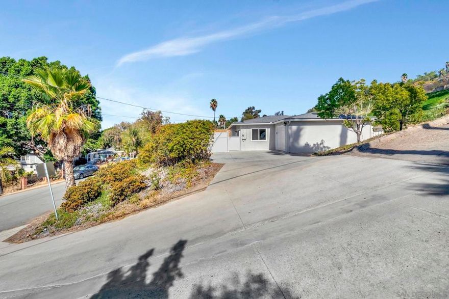 Tucked away in a peaceful Spring Valley neighborhood, this beautifully remodeled 2-bedroom home offers both privacy and charm. Perched on a hill with lovely views, the home features new luxury vinyl plank flooring, dual-pane windows, and stylish modern finishes throughout. The spacious kitchen is impressive with sleek cabinetry, quartz countertops, and plenty of room to cook and gather. The bathroom feels luxurious, and both bedrooms are light and thoughtfully updated. Enjoy outdoor living on the two decks and large patio areas—perfect for entertaining or relaxing. Additional highlights include a brand-new roof, a large one-car garage, and plenty of driveway parking. This home is move-in ready and beautifully finished.