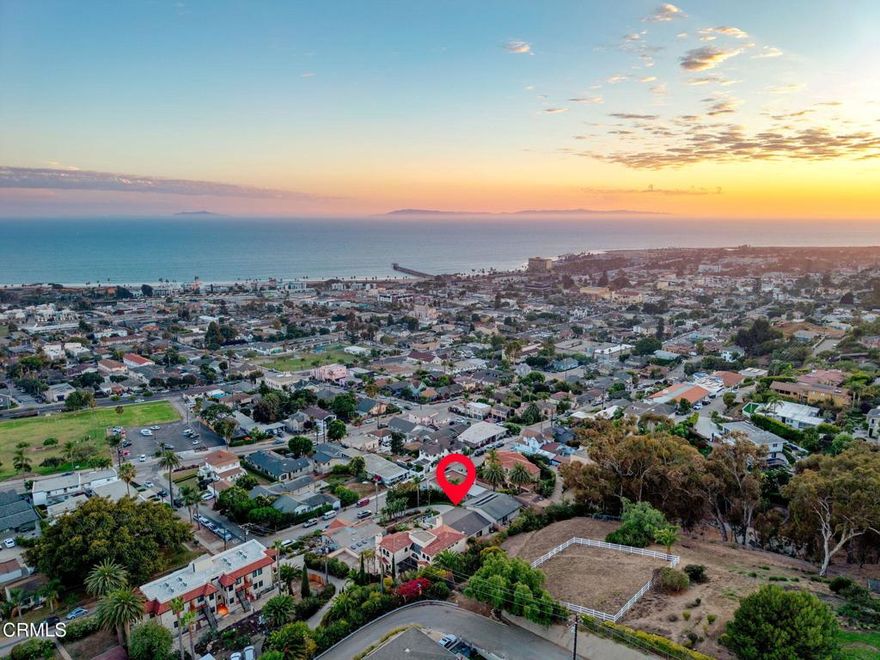 Come enjoy one of the best views in the City of Ventura!  This property is uniquely situated on an expansive almost quarter acre lot, with no direct neighbor in front, allowing for unobstructed views and privacy.  The design of the interior, with kitchen and primary bedroom upstairs and additional bedrooms down below, allows for the view to be capitalized on from the primary living spaces.  Enjoy unobstructed 180 views of the coastline, ocean, islands, and twinkling city lights while being just a short walk from Cemetery Park, the beach and Ventura's vibrant downtown.  The upper level features a light-filled living room, a remodeled kitchen and primary suite with en-suite bath. The kitchen is thoughtfully designed with granite countertops, stainless steel appliances, a walk-in pantry and a layout that lets you cook while taking in the breathtaking scenery. The living room, with its bamboo flooring, is the perfect place to relax, watch boats drift by and soak in the sunsets. Step out onto the view deck for an even more spectacular vantage point.  The primary bedroom includes a sliding glass door that fills the room with natural light and opens to a private backyard.  On the lower level, two additional bedrooms and a full bath provide comfort and privacy for guests.  A spacious hallway closet with shelving offers flexible use--perhaps even as a future wine cellar.  The two-car garage provides ample storage and even a view while you work. The unique lot design may allow for an additional street-level garage with a unit above (buyer to verify) and there's also space on the side of the home for a boat or small trailer.  The drought-tolerant landscaping, enhanced with irrigation, bursts into vibrant color each spring.  Homes with this rare combination of location, privacy, and sweeping views seldom come to market.  Don't miss your chance to make it yours!