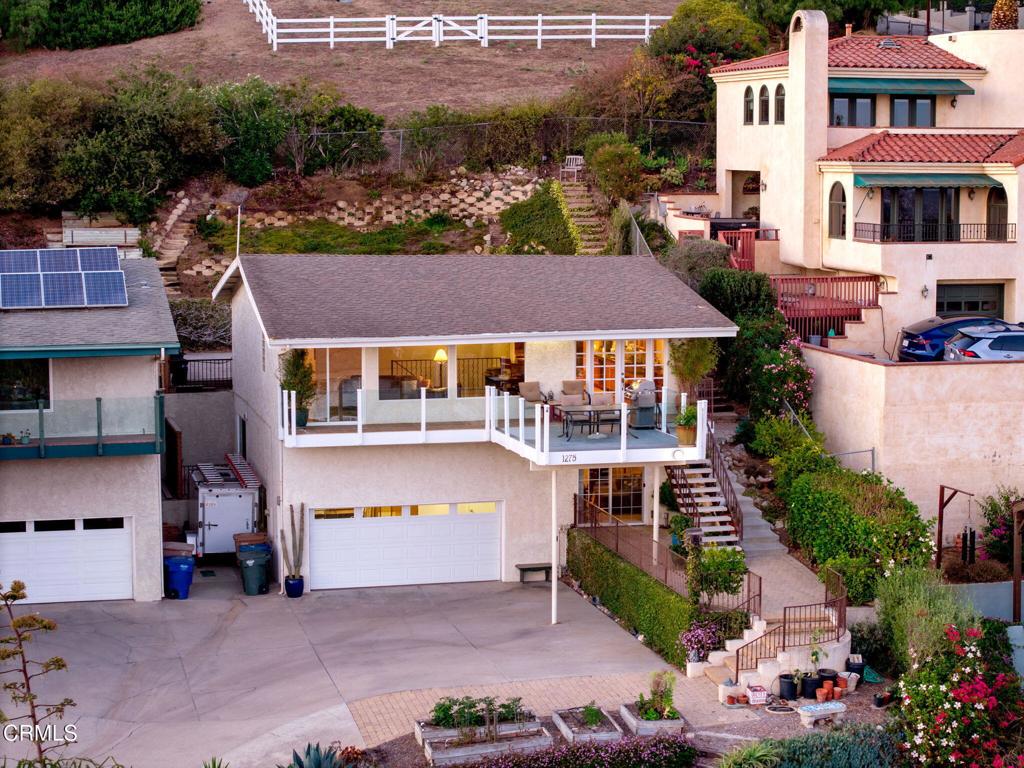 Come enjoy one of the best views in the City of Ventura! This property is uniquely situated on an expansive almost quarter acre lot, with no direct neighbor in front, allowing for unobstructed views and privacy. The design of the interior, with kitchen and primary bedroom upstairs and additional bedrooms down below, allows for the view to be capitalized on from the primary living spaces. Enjoy unobstructed 180 views of the coastline, ocean, islands, and twinkling city lights while being just a short walk from Cemetery Park, the beach and Ventura's vibrant downtown. The upper level features a light-filled living room, a remodeled kitchen and primary suite with en-suite bath. The kitchen is thoughtfully designed with granite countertops, stainless steel appliances, a walk-in pantry and a layout that lets you cook while taking in the breathtaking scenery. The living room, with its bamboo flooring, is the perfect place to relax, watch boats drift by and soak in the sunsets. Step out onto the view deck for an even more spectacular vantage point. The primary bedroom includes a sliding glass door that fills the room with natural light and opens to a private backyard. On the lower level, two additional bedrooms and a full bath provide comfort and privacy for guests. A spacious hallway closet with shelving offers flexible use--perhaps even as a future wine cellar. The two-car garage provides ample storage and even a view while you work. The unique lot design may allow for an additional street-level garage with a unit above (buyer to verify) and there's also space on the side of the home for a boat or small trailer. The drought-tolerant landscaping, enhanced with irrigation, bursts into vibrant color each spring. Homes with this rare combination of location, privacy, and sweeping views seldom come to market. Don't miss your chance to make it yours!