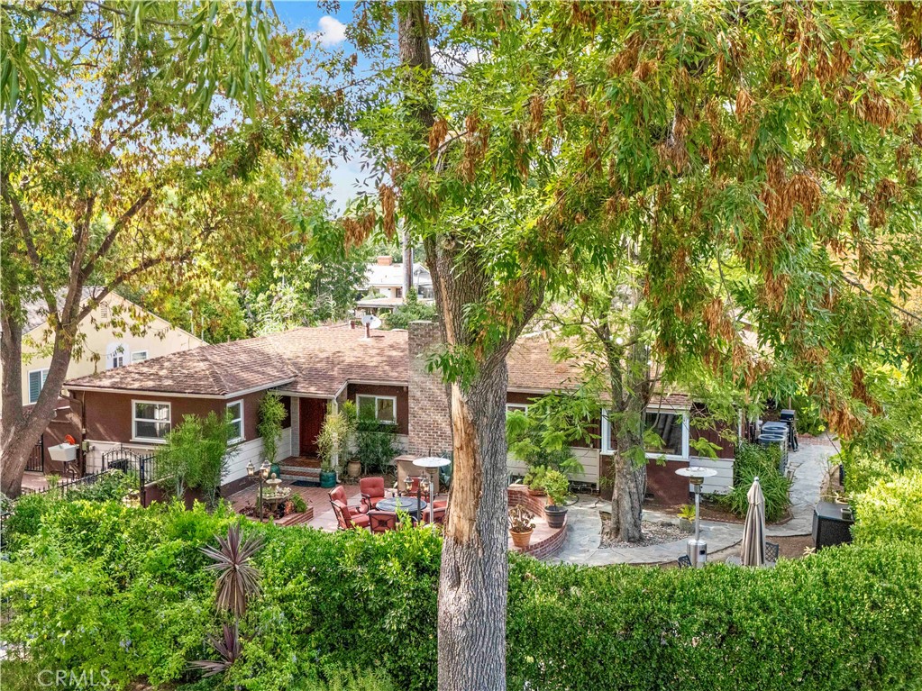 Private Ranch-Style Compound in Prime Valley Glen
Set on a sprawling corner lot, this fully gated and hedged single-story home offers rare privacy in a beautiful residential pocket known for its curb appeal. With multiple outdoor entertaining areas, a saltwater pool, spa, and covered patio, the property is a true retreat.
Inside, the flexible floor plan spans approximately 3,100 sq ft and includes 4 bedrooms, 2 bathrooms, 2 dens, 2 living rooms, and 2 laundry rooms—ideal for extended family, multi-generational living, or creating separation between spaces.
The main living room features wood-beamed ceilings, hardwood floors, a fireplace, and formal dining. Skylit dens open directly to the backyard for seamless indoor-outdoor living.
At the center of it all is a chef’s kitchen with a Viking commercial-grade range and vent hood, dual ovens, stone countertops, stainless steel appliances, and custom cabinetry.
Additional highlights:
Dual-pane windows
Insulated crawl space
Recessed lighting
Custom baseboards
A rare and versatile opportunity in a sought-after Valley Glen location
