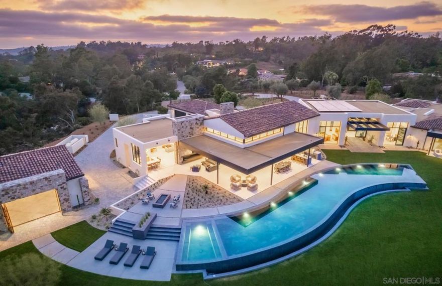 Welcome to the "One" 5385 Linea Del Cielo. A Rancho Santa Fe, West Covenant Estate, a true masterpiece of contemporary design and architectural brilliance. This new construction custom estate offers a stunning array of features that redefine luxury living. As you approach the entrance, you'll be greeted by a striking cantilevered steel beam standing boldly, a testament to the home's modern aesthetic and structural elegance. This architectural marvel sets the tone for the remarkable experience that awaits within. Step inside and prepare to be amazed by the seamless glass pocket doors that effortlessly connect the indoor and outdoor spaces. These magnificent doors dissolve the boundary between the interior and the surrounding natural beauty, creating a seamless transition and a sense of harmony with your surroundings. The great room, adorned with 21-foot cathedral ceilings, becomes a focal point of grandeur and spaciousness. Bask in the natural light that pours through the expansive transom windows, creating an airy and inviting atmosphere. The 130-foot infinity pool, a centerpiece of luxury, beckons you to indulge in its shimmering waters and revel in the serenity of your own private oasis. Lounge by the poolside, entertain guests, or simply unwind in the lap of luxury. The grand master suite and bath continue the theme of opulence and refinement. Retreat to your sanctuary and experience the pinnacle of comfort and relaxation in a space designed with your utmost comfort in mind.  Nestled on an expansive 10-acre estate, this property offers a sense of privacy, security and tranquility. The vast outdoor space is a canvas for your imagination, inviting you to create the outdoor sanctuary of your dreams. The 2 bed 2 bath detached guest home with showroom/ flex space provides a versatile area that can adapt to your personal needs. Whether you envision a home office, an artist's studio, car collectors' showroom, or a private gym, this space offers endless possibilities. With a vineyard as part of this remarkable estate, you can immerse yourself in the art of winemaking and enjoy the fruits of your labor in the serene beauty of your surroundings. Three full gourmet kitchens with Miele appliances. Outdoor BBQ Islands. Walk-in temperature-controlled wine cellar and wine lounge. Whole home custom surround sound/whole house media, security and smart gate controller with cameras mean you are protected and connected. Embrace the opportunity to own this extraordinary RSF West Covenant Estate, where architectural brilliance meets luxurious resort style living. Contact us today to schedule an exclusive tour and immerse yourself in the unparalleled beauty and elegance of this exceptional property.
