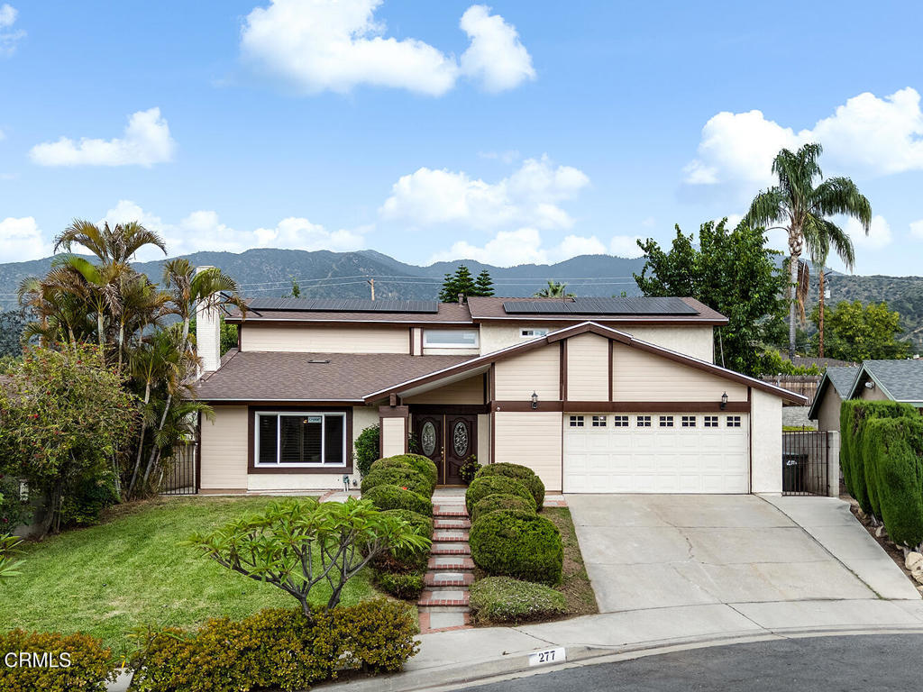 Nestled on a quiet cul-de-sac north of Foothill, this south-facing, updated 5-bedroom, 4-bathroom home offers both elegance and comfort. A grand double entry door welcomes you into the spacious living room, featuring tile floors, recessed lighting, vaulted ceilings, and a handsome fireplace. The adjacent dining room flows seamlessly into the updated kitchen, complete with granite counters, glass tile backsplash, stainless steel appliances, and breakfast bar. The kitchen opens to the inviting family room and leads to a covered outdoor patio--perfect for relaxation or entertaining. The ground-floor master suite boasts ample closet space and a beautifully renovated bathroom, while a full guest bathroom and direct access to the attached 2-car garage complete the first level. Upstairs, you'll discover four generously sized bedrooms, each filled with natural light and offering picturesque mountain views through their windows. And there are two updated bathrooms featuring over-sized vanities and spa-like tubs. The private backyard offers a lush retreat with fig, mulberry, orange, pomegranate, and persimmon trees. Additional home features include new roofing with solar panel, new HVAC system and new windows. This move-in-ready home sits in Monrovia's desirable foothills, offering serenity and easy hiking trail access. Just minutes from Old Town's shops, dining, and parks, it blends tranquility with convenience--a rare opportunity!