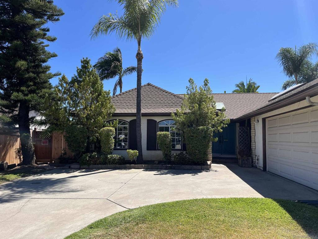 Tucked away on a quiet street, this inviting 3-bedroom, 2-bathroom home offers a serene escape with a beautifully landscaped backyard oasis. Step out from the primary bedroom onto a shaded deck — the perfect place to relax on warm summer days. The spacious kitchen features solid-surface countertops, wood cabinetry, and a bright breakfast area that opens seamlessly to a large patio with skylights, ideal for outdoor entertaining. The kitchen flows into the dining area, which connects to a generous living room with a cozy fireplace — perfect for cooler evenings. A 2-car garage adds convenience, and mature landscaping completes the tranquil setting. This home blends comfort, charm, and functionality — ready for you to move in and enjoy.