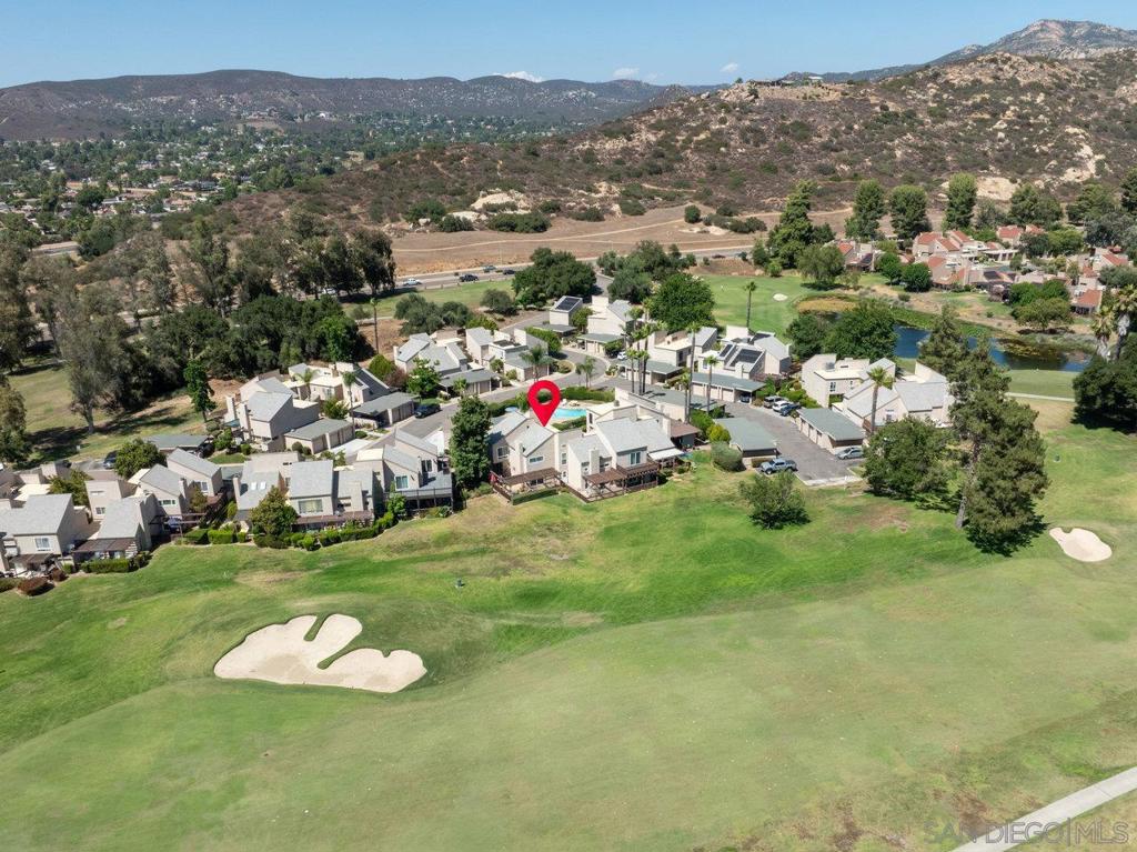 Golf Course Living at Its Finest! Welcome to this beautifully appointed 2+ bedroom, 2.5 bath condominium nestled on the lush fairways of the San Vicente Golf Course, a premier 18-hole championship course in the heart of Ramona. Boasting 1,674 square feet of thoughtfully designed living space, this home combines comfort, style, and panoramic golf course views. Step inside to discover a light-filled open floor plan with spacious living and dining areas—perfect for entertaining or relaxing in style. The galley kitchen features sleek granite countertops, ample cabinetry, and a seamless flow. Upstairs, you'll find all bedrooms for optimal privacy. The primary suite is a true retreat with a picture window framing breathtaking views of the fairway, a private en-suite bath with walk-in shower, and ample storage in the walk-in closet. The extra room offers versatility as a guest bedroom, home office, or hobby space—complete with its own walk-in closet. What truly sets this condo apart is the expansive wrap-around "L" shaped patio, where you can unwind and soak in the serene golf course vistas all day long.