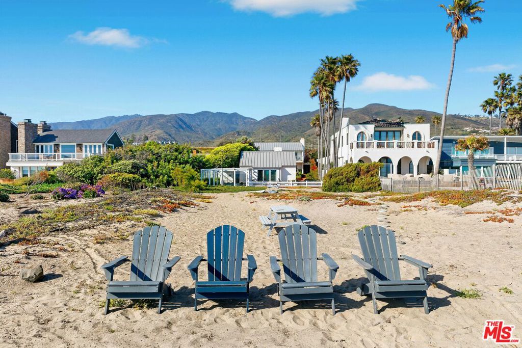 Welcome to one of Malibu's most iconic beach homes, set on the widest stretch of dry sand in the most coveted section of the coastline. With 55 feet of ocean frontage and an exceptional depth of usable beachfront, this two-bungalow property offers unmatched space, privacy, and connection to the sea, perfect for barefoot luxury living. Once the seaside escape of Hollywood icon Audrey Hepburn, this rare legacy property blends Old Malibu charm with modern updates. The main residence has been beautifully remodeled, featuring a gourmet kitchen, fresh stucco exterior, new floors, and a new roof. A separate, fully equipped guest house offers three additional bedrooms ideal for hosting friends or extended stays. The home is being offered fully furnished, complete with dishes, flatware, beach toys, and an outdoor fire pit for evening gatherings by the surf. Move in and start living the Malibu dream immediately. Included with the property are submitted architectural plans for a stunning new beachfront home already in review with the City of Malibu, giving future owners an exceptional opportunity to build their dream estate while enjoying the current home.