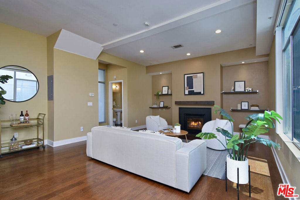 Situated south of the Boulevard in Studio City, this thoughtfully designed 3-bedroom, 3-bathroom corner-unit condo offers 1,870 square feet of comfortable, well-appointed living space. The main level features an open-concept layout with hardwood floors, recessed lighting, and a fireplace, seamlessly connecting the living, dining, and kitchen areasideal for both everyday living and entertaining. The kitchen is equipped with stainless steel appliances, granite countertops, and ample cabinet storage, flowing effortlessly into the formal dining area and out to a private patioperfect for morning coffee or outdoor dining. On the second floor you will find three spacious bedrooms. The primary suite features hardwood floors, soaring ceilings, a large walk-in closet, and a beautifully upgraded en-suite bath with dual vanities, a soaking tub, and a walk-in shower. A third-story loft overlooks the primary bedroom and is well-suited for a home office or flex space, leading directly to a private rooftop patio with scenic views. Additional highlights include gated side-by-side parking, a private storage room, and access to the building's gym. Located within walking distance of Carpenter Elementary School and Ventura Blvd's vibrant dining and shopping options, this home blends style, comfort, and convenience.