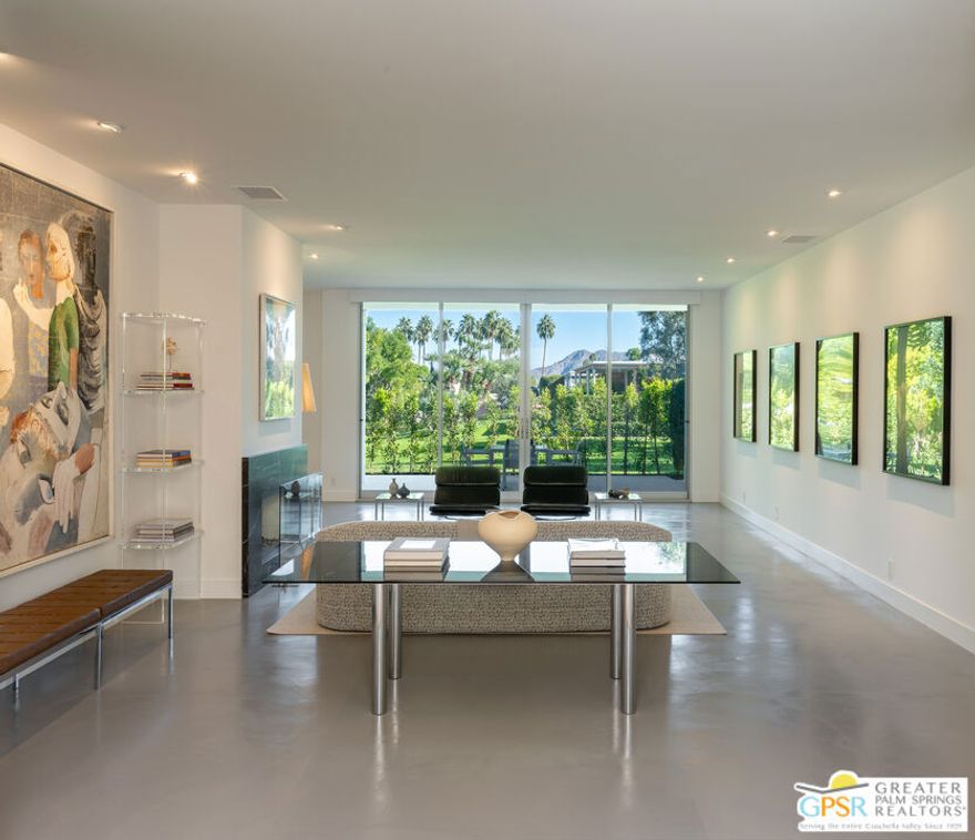 Situated in prestigious Marrakesh Country Club, this John Elgin Woolf designed Hollywood Regency Villa is a pinnacle of modern luxury. Remodeled by renowned celebrity photographer, Firooz Zahedi, author of several books including "My Elizabeth" on Elizabeth Taylor.  This three-bedroom, three-bathroom, 2,427 square foot home is the largest of the original floor plans with the remodel completed in October 2025. Enter through the west-facing courtyard beautified with new hardscape and soft, lush landscaping scaling the exterior walls.  Through iconic Marrakesh double doors lies a stunning, high-end modern renovation representative of a caliber that is higher than standard. The tall ceilings, extremely smooth white walls, new modern sliders and modern shades enhance light and set the mood throughout the home.  In the living room, the black marbled fireplace, recessed art lighting and electric dual sun/blackout shades allow for the manipulation of light to your choice of ambience.  Large new sliders frame stunning mountain views and the enormous green space behind.  The expanded kitchen footprint allows for modern living with stainless steel appliances, gas cooking, modern gloss cabinetry, wine refrigerator and ample counter space. All bedrooms have private, en-suite baths with Restoration Hardware vanities in all baths.  The primary bedroom includes a spacious bathroom with standalone tub, separate marble shower, new vanities, plumbing and fixtures.  The walk-in closet includes custom shelving and organizers, and built-in laundry basket and wall storage.  The secondary bedroom suite have been expanded to include a separate seating or office area, built-in closets and en-suite bathroom with shower.  The third bedroom also includes an en-suite bathroom with shower and access to the front courtyard. Stackable laundry is hidden with convenient shelving and separate wash basin. Additional features include: a tankless water heater, two newly installed HVAC systems, two-car garage with EV Charging port, new electrical subpanel, new sliders/windows and a 38 panel/11.21kW solar system. Marrakesh is a boutique country club with an ideal central valley location amongst a few of the desert's finest private clubs. Amenities include 18-hole private executive golf course, tennis, pickleball, 14 pools and spa, a fitness center, and an active and newly-remodeled clubhouse with fine dining. Marrakesh is near famous El Paseo with all of its elegant boutiques, restaurants, art galleries, and coffee houses. Come experience Marrakesh Country Club.  Furniture and Art available outside of escrow separate from the listing price.