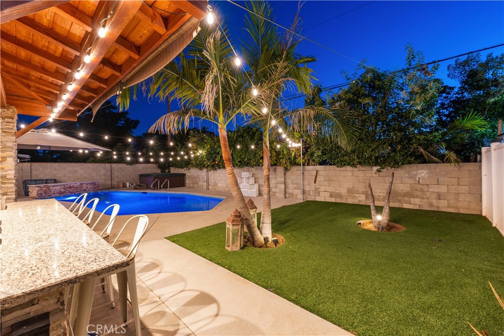 Welcome to this beautifully remodeled home in a prime Reseda neighborhood, adjacent to Tarzana. Enjoy a mature garden and palm trees for great curb appeal. The bright living room leads to 3 spacious bedrooms and 2 bathrooms, including a master suite retreat with a walk-in shower and soaking tub.
The home features a modern, charming kitchen, a convenient laundry room, central air & heat, dual-pane windows, a newer roof, and a tankless water heater.Relax in the backyard oasis with a sparkling pool, spa, palm trees, a covered patio, and a granite outdoor kitchen with built-in barbecue. The property offers an upgraded ADU with its own address, separate water and Electric meter one bedroom, a living room, and a kitchenette. An oversized driveway provides plenty of parking. Close to Pierce College, CSUN, and major freeways. Move-in ready and not to be missed!