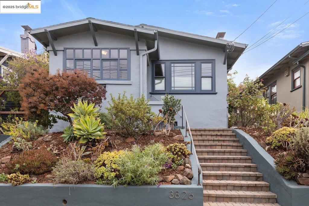 Raised and set back from the street, this classic Craftsman pairs soulful character with fresh, practical upgrades. Warm living and dining rooms show off rich wood paneling, original built-ins, and Marvin wood-clad dual-pane windows that hush the outside world. The layout moves easily, while period details give the home a grounded, timeless feel. The kitchen offers real working room with ample counters and storage, ready for weeknight speed or relaxed weekend cooking. The refreshed, generously sized bath reads clean and current. A window-lined bonus room makes an inspiring home office, art studio, or play zone. Outside the garden is set for low-effort living: a fully paved patio for dining and lounging, raised garden beds for herbs and veggies, and two spacious, rock-solid storage sheds—ideal for bikes, tools, or a tidy workshop. Systems are dialed for confidence: earthquake retrofitting, newer attic insulation, mini-split air conditioning, tankless water heater, newer furnace, and sewer lateral compliance. Location seals it. Everyday amenities, neighborhood parks, and local cafes within reach, reinforce the sense of a connected, welcoming community. With authentic charm and smart updates, 3826 Lincoln Ave delivers energized Oakland living—move-in ready and easy to love.