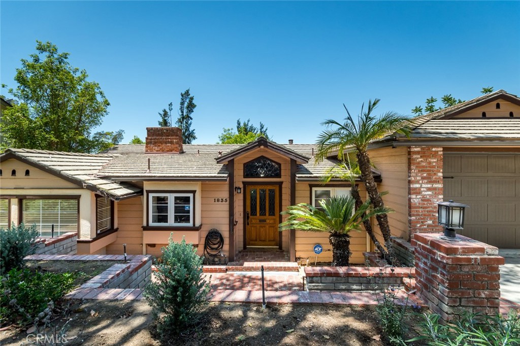 Tucked away on a peaceful street in the desirable Greenbriar neighborhood of north Glendale, this charming home has been lovingly cared for by the same owners for nearly 40 years. A gracious formal foyer introduces the home, where handsome wood clad ceilings in both the entry and living room lend instant character. Step into the inviting living room, where open-beam ceilings and treetop views create a warm and tranquil atmosphere. The spacious living room is open to a generous dining area, ideal for entertaining. The large kitchen offers abundant cabinets and opens to a casual dining area, perfect for morning coffee or weeknight dinners. Upstairs, you'll find two bedrooms, each with tranquil treetop vistas and abundant natural light. The primary suite is conveniently located on the lower level, featuring an updated en-suite bath with an oversized walk-in shower. A cozy family room on the lower level boasts French doors that open to the serene backyard, offering easy indoor-outdoor living. The backyard is a true retreat—private and peaceful—with mature trees, a garden area, a spacious patio, and a deck that’s perfect for relaxing or entertaining under the canopy of nature. The property also features a 2-car garage and central heat and A/C.
