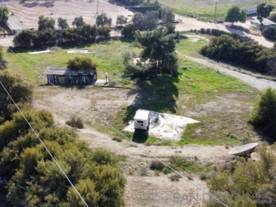 Come by and see this prime land lot offering investment and tranquility.  This exceptional land parcel presents a unique opportunity for both lucrative investment and the creation of an idyllic sanctuary. Nestled against the backdrop of majestic mountains and boasting panoramic views of the surrounding cities, the potential applications for this land are truly limitless.Some of the key features include; Multiple Access Points: Accessible from three distinct driveways, this expansive property offers convenient and flexible entry options. Strategic Grading: The land has been meticulously graded with four or more layers, providing a pre-prepared canvas for the construction of a residence. Notably, the top tier features a substantial 40x40 concrete slab, the third level boasts a 35x35 concrete foundation, and the lower level includes a generously sized single-wide concrete slab.The property is already equipped with essential utilities, including electric connections (requiring a new meter), septic tank, and water lines. Additionally, a shared well with neighboring properties ensures a reliable water source. The perimeter of the lot is adorned with mature trees, enhancing privacy and adding a natural aesthetic appeal to the surroundings. Stop on by to take a look at this blank canvas and see what you would turn it into.