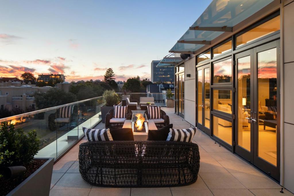 Rare penthouse residence in downtown Palo Alto. 3,517 sf living space and an additional 4,025 sf private terrace outfitted with a high-end sound system, beautiful lighting, fire pits and fountain for indoor/outdoor California living.  Entertain in style with an impressive great room with double-sided fireplace, climate-controlled wine room, well-appointed outdoor kitchen and multiple dining and seating areas on the terrace. The stylish kitchen features premium appliances, limestone countertops and sleek SieMatic cabinetry.  The main suite and guest bedroom provide luxury accommodations to residents and visitors alike, each with access to outdoor deck space. The office/den is perfect for working from home. Automatic shades, sound, HVAC, lighting and televisions all conveniently operated by a newly upgraded Control 4 system.  4 parking spaces and an impressive 2,200-bottle wine cellar are found in the building's secure underground garage. An exceptional property in a premier location.