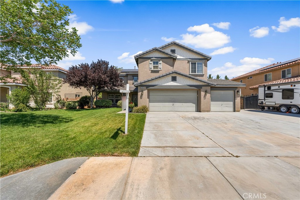 Welcome to 43446 Honeybee Lane - a beautifully upgraded 4-bedroom, 3-bathroom home in one of West Lancaster's most sought-after neighborhoods! This spacious and flexible floor plan includes a downstairs bedroom and a separate office, perfect for guests, remote work, or a quiet retreat. The main level features vaulted ceilings, formal living and dining areas, and a cozy family room with fireplace. The kitchen is a chef's dream with quartz countertops, a center island, and plenty of cabinet space. Upstairs, you'll find a massive loft offering endless possibilities as a game room, media space, or second living area. The oversized primary suite includes a walk-in closet, soaking tub, separate shower, and dual vanities. Outside, enjoy a private backyard with a covered patio ideal for entertaining or relaxing. Complete with a 3-car garage, possible RV access, and close to schools, shopping, and parks—this home is move-in ready and has it all. Don't miss this incredible opportunity!